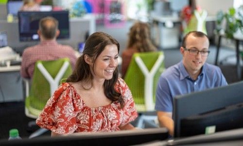 Bespoke colleagues sat together looking at a computer